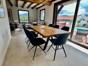 a dining room with a wooden table and chairs at Villa Goxoki in Urrugne