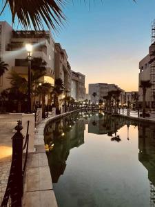 a canal in the middle of a city with buildings at Palm Lake Ressort Monastir S2 in Monastir
