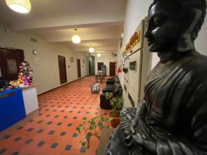 a statue of a woman standing in a hallway at La Paradise Residency in Puducherry