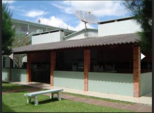 a building with a bench in front of it at Apartamento vista pro mar in Tramandaí +7 photos