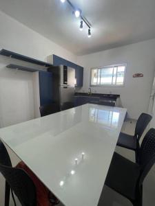 a conference room with a white table and chairs at Apartamento vista pro mar in Tramandaí
