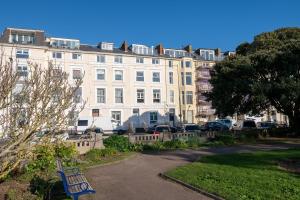 a large white building with cars parked in front of it at Seaview Central in Portsmouth