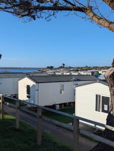 a row of mobile homes on the side of a road at Relaxing Holiday Home Chickerell View Littlesea Haven in Weymouth