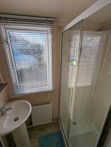 a bathroom with a shower and a sink at Relaxing Holiday Home Chickerell View Littlesea Haven in Weymouth