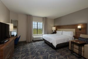 a hotel room with a bed and a television at Candlewood Suites - Corpus Christi - Portland, an IHG Hotel in Portland
