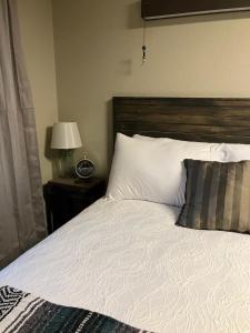 a bedroom with a large bed with a wooden headboard at Prairie Rose Inn in WaKeeney