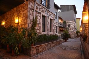 a stone building with plants on the side of it at Lovely Garden Flat with Patio near Hadrian's Gate in Antalya