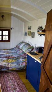 a bedroom with a bed and a desk with a computer at Pooks Rest in Hurst Green