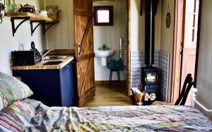 a kitchen with a sink and a stove in a room at Pooks Rest in Hurst Green