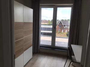 a room with a large window with a view at Residentie Sluispark in Ghent