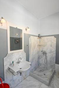 a bathroom with a sink and a shower at Spectacular View in Istérnia +23 photos