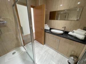 a bathroom with a shower and a sink at Riverside Park & Country Club in South Molton