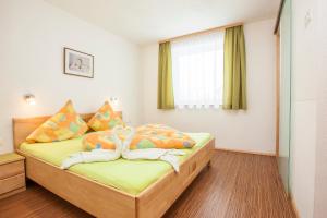 a bedroom with a bed with towels on it at Conny's Apartments in Neustift im Stubaital