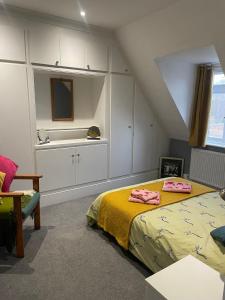 a attic bedroom with a bed and a sink at Modern Centrally Located Flat in Hastings