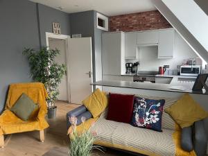 a living room with a couch and a kitchen at Modern Centrally Located Flat in Hastings