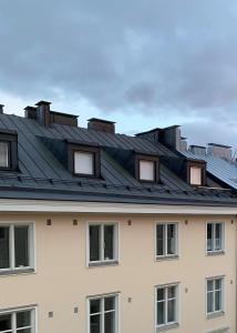 a building with solar panels on the roof at Central Helsinki Punavuori 40m2 entire flat in Helsinki