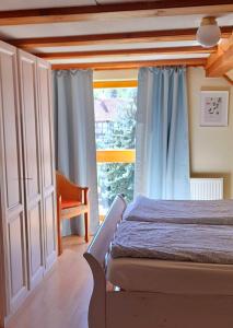 a bedroom with a bed and a large window at Bauernhof Wagner in Eisenach