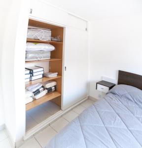 a bedroom with a bed and a closet at Cañada 2 dorm in Cordoba