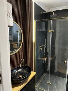 a black bathroom with a sink and a shower at High Standard Room in Jewish District, Apartment Shared with Host in Krakow