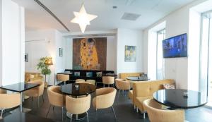 a restaurant with tables and chairs and a star on the wall at Safestay Vienna Margaretenviertel in Vienna