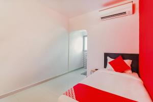 a bedroom with a red and white bed at Flagship Hotel Maruthi Gandhi Park in Coimbatore