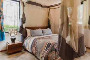 a bedroom with a bed and a window at Mama Tembo Cheza 01 in Lusaka