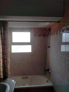 a bathroom with a bath tub and a window at Jasmine Nile Sky Hotel in Cairo