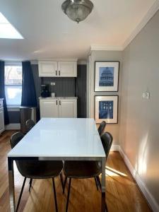 a dining room with a white table and chairs at Large studio apartment steps from the US Capitol! in Washington