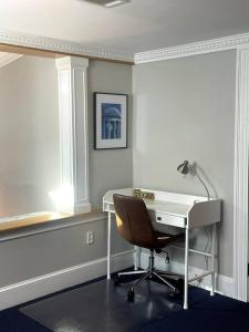 a office with a desk and a chair and a lamp at Large studio apartment steps from the US Capitol! in Washington, D.C.