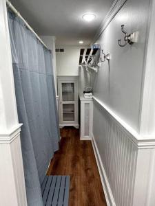 a hallway with a shower and a bench in a room at Large studio apartment steps from the US Capitol! in Washington