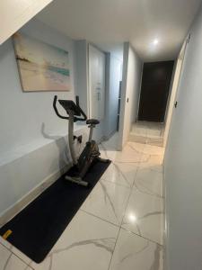 a room with a gym with a exercise bike at Mara Boutique Apartments 1 in Oldbury