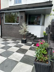 a house with a black and white checkered floor at Mara Boutique Apartments 1 in Oldbury