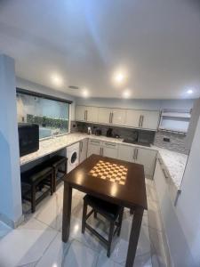 a kitchen with a table in the middle of it at Mara Boutique Apartments 1 in Oldbury