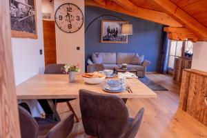 a living room with a table and a couch at Broathack in Garmisch-Partenkirchen +11 photos