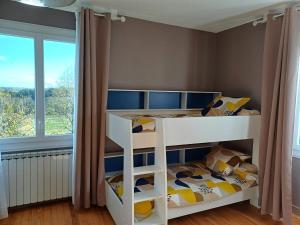 a white bunk bed in a room with a window at Maison au cœur de notre ferme familiale in Asson
