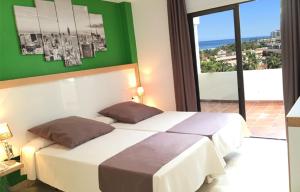 a bedroom with a bed with a view of the ocean at Apartamentos Bahia Playa in Puerto de la Cruz