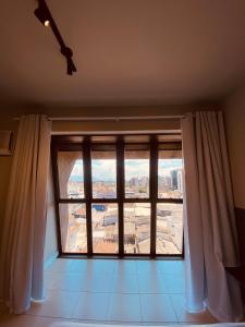 a large window with a view of a city at Excutive apartamentos in Joinville