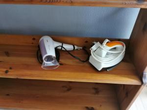 a wooden shelf with a hair dryer and a blow dryer on it at 118 Island Plaza Suite City8 by Joal in Tanjong Tokong