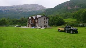a jeep parked in a field in front of a house at Hotel Casa Chuldian in Sahun