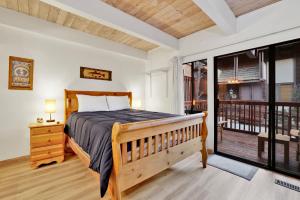 a bedroom with a bed and a balcony at 2354-Chairlift Lodge condo in Big Bear Lake