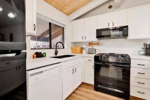 a kitchen with white cabinets and a black stove top oven at 2354-Chairlift Lodge condo in Big Bear Lake