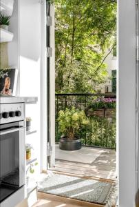 uma porta aberta para uma varanda com um vaso de plantas em Alexander Kiellands plass - City Center Oslo em Oslo