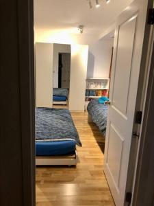 1 Bedroom Flat near Excel, O2, Canary Wharf - London في لندن: غرفة بسريرين وباب لغرفة النوم