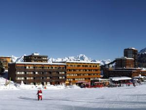 a person on skis in the snow in front of buildings at Appartement La Plagne, 2 pièces, 5 personnes - FR-1-455-78 in La Plagne