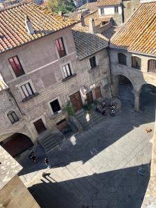 an overhead view of a building with motorcycles parked in front at Torre degli Alessandri in Viterbo