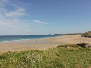 a beach with a group of people on the sand at Lapwing in Perranporth