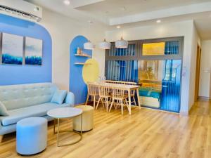 a living room with a blue couch and a table at TMS Sea Condotel Quy Nhơn in Quy Nhon