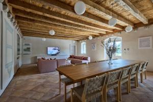 a large dining room with a wooden table and chairs at Renaissance Palace Ghetaldi 1516 in Suđurađ
