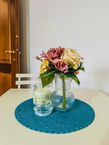 een vaas met een boeket bloemen op een tafel bij La casita A&B in La Spezia