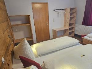 a room with two beds and shelves in it at Ferienhaus Schwendehof in Fontanella